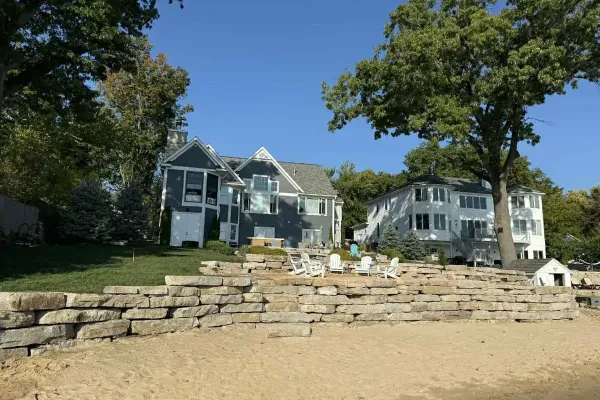 Retaining wall with integrated landscape grading