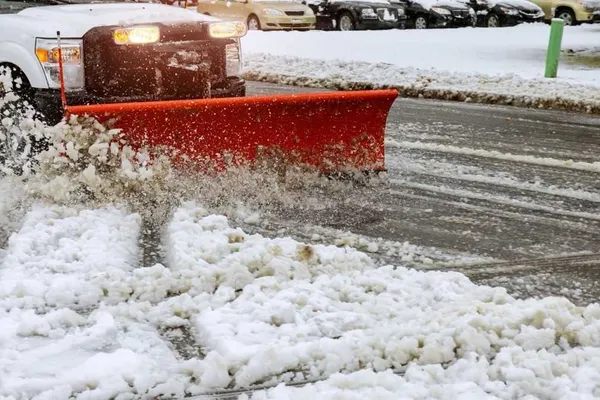 Snow plowing equipment clearing a parking lot